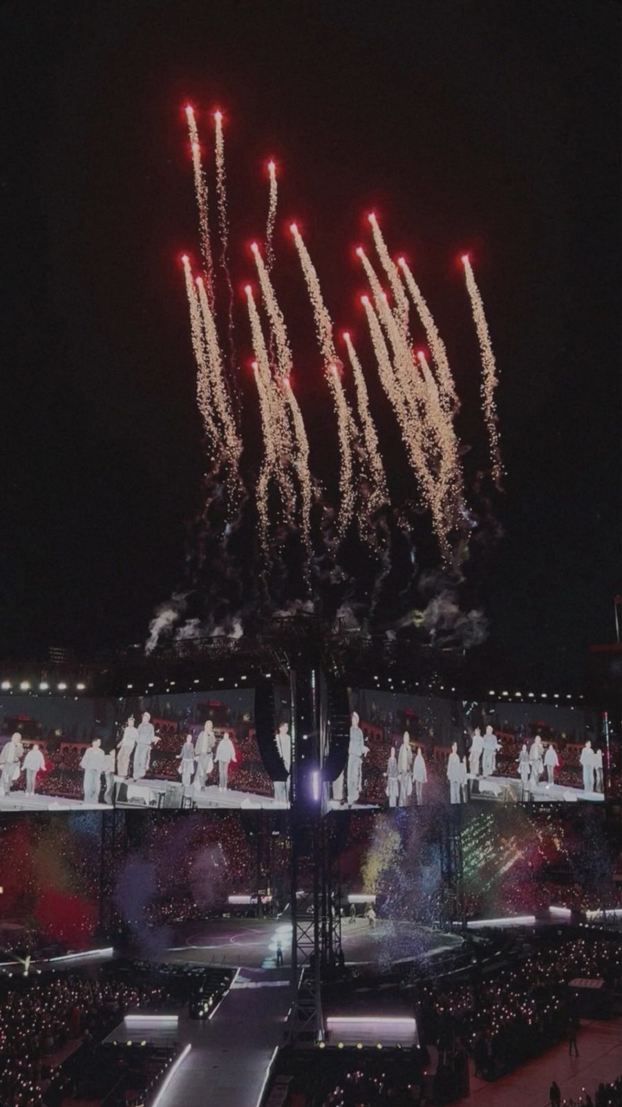 BTS performing at the ARIRANG World Tour, May 2026, fireworks erupting over the stadium stage